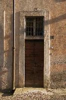 Door of building in Arona in oblique light, wall, door, shadow, sunlight, facade, exterior, arona, piemonte, italy, europe, building