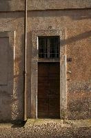 Door of building in Arona in oblique light, wall, door, shadow, sunlight, facade, exterior, arona, piemonte, italy, europe, building
