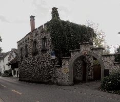 Arched entrance to courtyard of old, stone building in Swiss town of Baar, caves, traditional, building, street, exterior, courtyard, outdoors, rock, summer, crenelleted, höllgrotten, stone, baar, archway, switzerland, walls, europe, rural