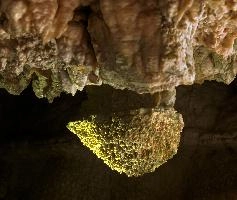 Höllgrotten Cave: Calcite formations clearly showing the old waterline from before the opening of the caves, under a pink-tinted rock ceiling, alps, flow, underground, tiers, calcite, baar, formation, höllgrotten, stone, yellow, material, cream, rock, nature, cave, geology, speleology, color, drop, subterranean, switzerland, european, stalactite