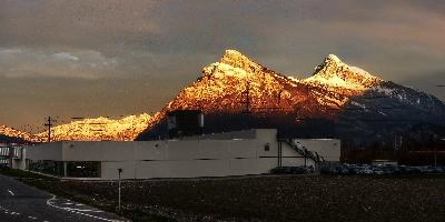 Alpenglow at dawn on the Gonzen, Alvier and Churfirsten, seen from Bad Ragaz, light, factoy, alpenglow, business, alvier, hiking, gonzen, walking, peaks, stone, mountains, rock, alpine, snow, churfirsten, alps, warm, stree, swiss, sunrise, building, switzerland, dawn, elesta gmbh
