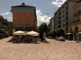 Open-air cafe and buildings in station area, Bellinzona in Grisons, street, italian, europe, switzerland, grisons, sunlight, bellinzona, summer, station, town, buildings, avenue, café, paved, open-air, diners