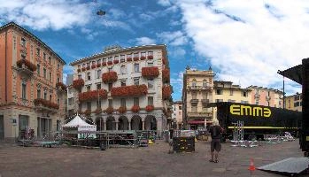 Concert in Lugano, outdoors, daytime, urban, blue sky, tessin, truck, lugano, stage, piazza, ornate, swiss, sunlilght, city, clouds, switzerland, building, italianate, square, grand, buildings, tourism, flowers, preparation, italian, town, lorry, ticino, concert, old, summer, geraniums
