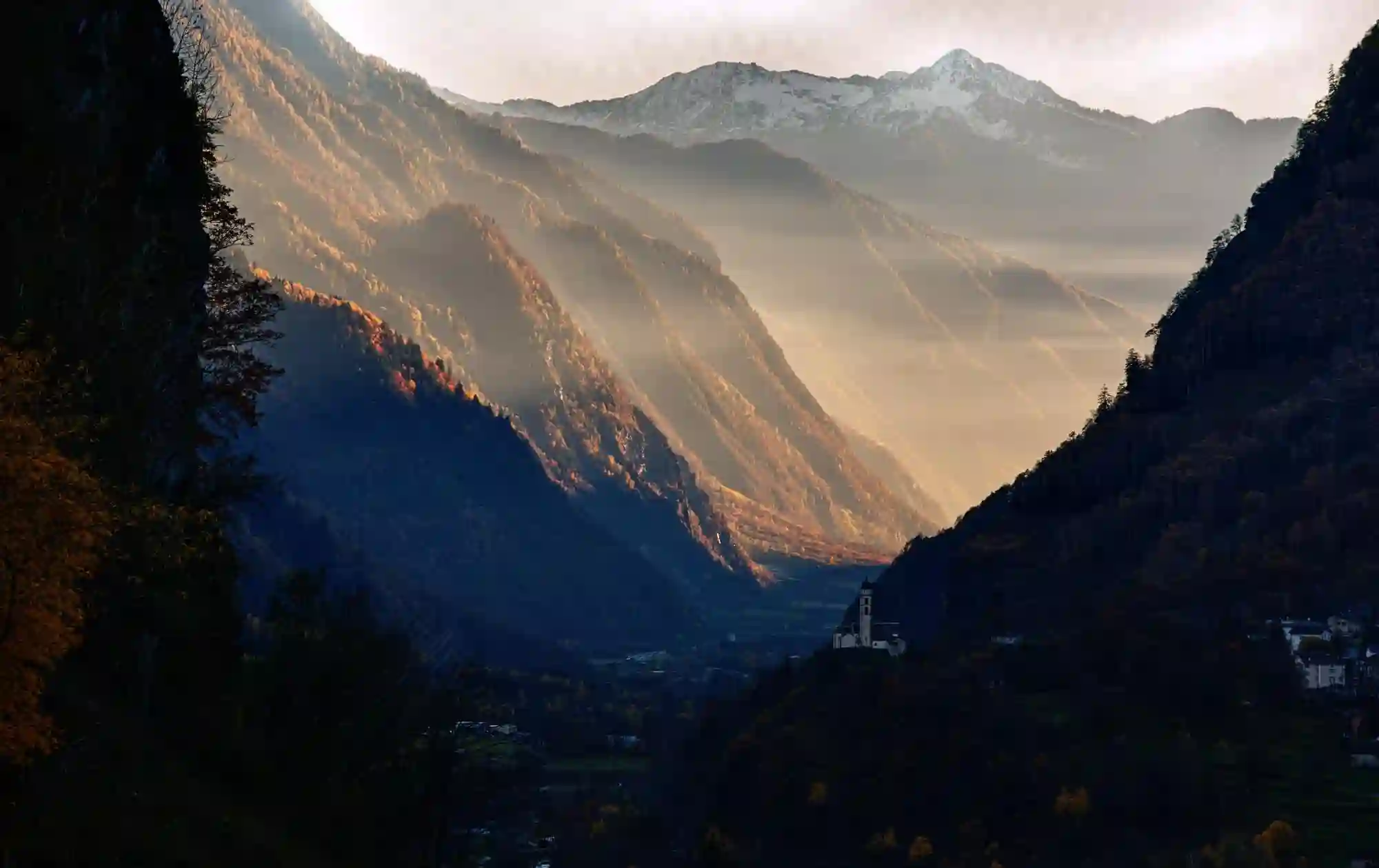 View South from Mesocco in the Swiss Canton of Grisons, europe, switzerland, graubünden, mesocco, alps, mountains, woodland, autumn, foliage, leaves, colour, church, south, sunlight