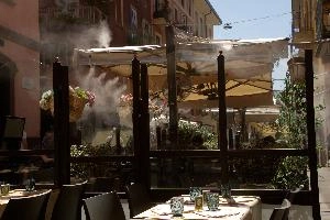 Cafe in Milano, italy, air-conditioning, spray, cooling, seating, heat, milan, water, europe, café, summer, street, sun, steam, tables, restaurant