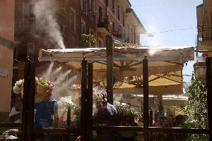 Cafe in Milano, italy, air-conditioning, spray, cooling, seating, heat, milan, water, europe, café, summer, street, sun, steam, tables, restaurant