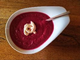 Bright red beetroot soup with a swirl of horseradish on oak table, table, spoon, plate, bowl, soup, sauce, horseradish, bright, red, oak, beetroot, wooden