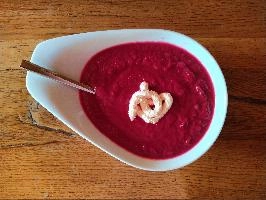 Bright red beetroot soup with a swirl of horseradish on oak table, table, spoon, plate, bowl, soup, sauce, horseradish, bright, red, oak, beetroot, wooden