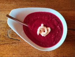 Bright red beetroot soup with a swirl of horseradish on oak table, table, spoon, plate, bowl, soup, sauce, horseradish, bright, red, oak, beetroot, wooden