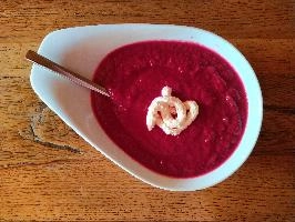 Bright red beetroot soup with a swirl of horseradish on oak table, table, spoon, plate, bowl, soup, sauce, horseradish, bright, red, oak, beetroot, wooden