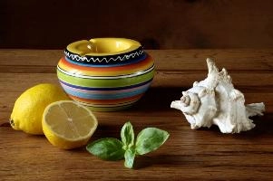 Still life of colourful ashtray with seashell, lemon and basil leaves, europe, switzerland, sankt, gallen, walenstadt, table, wooden, still-life, ashtray, ceramic, shell, basil, lemon, cut, fruit, herbaceous