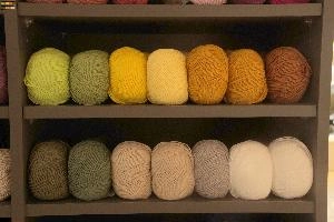Green and Ochre Wools, buchs, fibre, display, shelves, supply, balls, europe, fabric, switzerland, provisions, wool, natural, material, shop, knitting, colourful