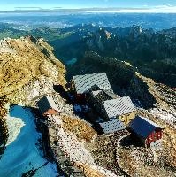 View from Säntis in Appenzell at daybreak, showing the old station buildings just below the peak., range, station, peaks, old, säntis, weather, mountains, daybreak, shelter, alpine, earl, ski-lift, swiss, morning, slate, appenzell, view, grey, saentis, scenery, roof, alps, stone, rooves, switzerland, rock, buildings