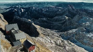View from Säntis in Appenzell at daybreak, showing the old station buildings just below the peak., range, station, peaks, old, säntis, weather, mountains, daybreak, shelter, alpine, earl, ski-lift, swiss, morning, slate, appenzell, view, grey, saentis, scenery, roof, alps, stone, rooves, switzerland, rock, buildings