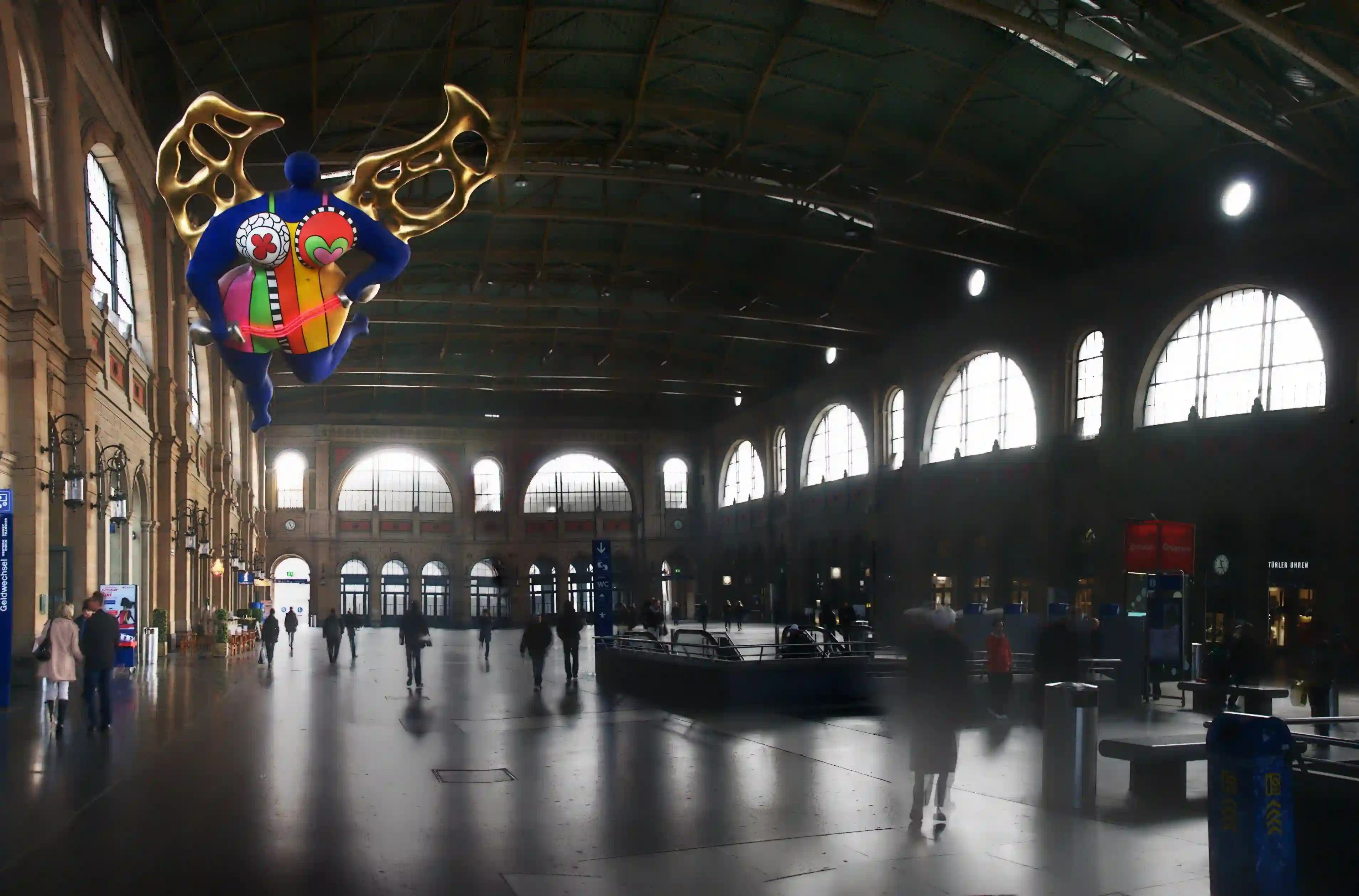 Evening light in the railway station of Zürich showing L’ange protecteur, zürich